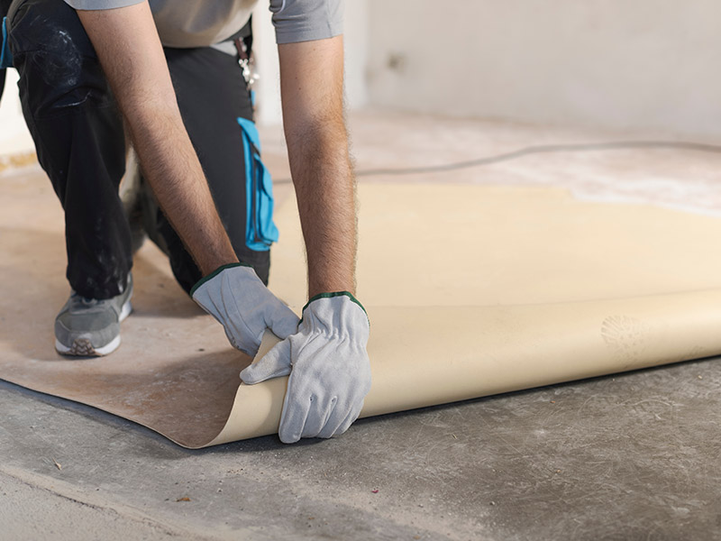 Eine Person entfernt einen Linoleum-Boden.